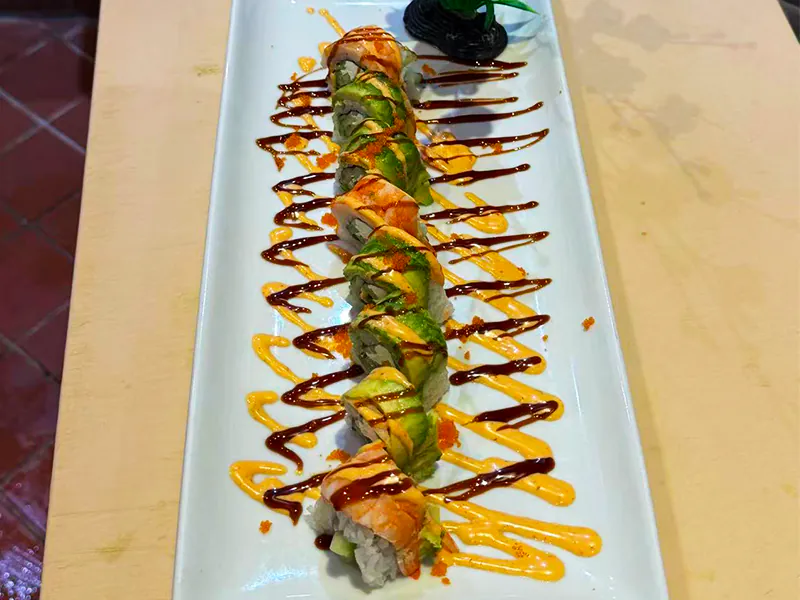 Crisp sushi roll with avocado & shrimp, topped with sauces at Kublai Khan Crazy Mongolian Stir Fry & Sushi Bar, a Asian Restaurant in Austin