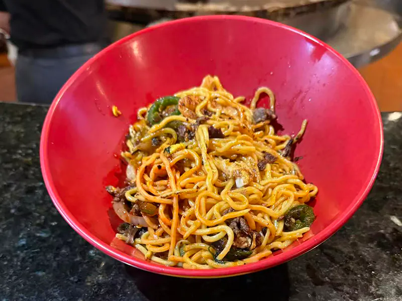 Wok-tossed noodles with veggies & meat at Kublai Khan Crazy Mongolian Stir Fry & Sushi Bar, a Asian Restaurant in Austin